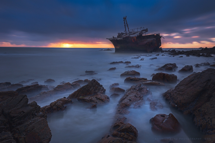 Seascape shipwreck at sunset
